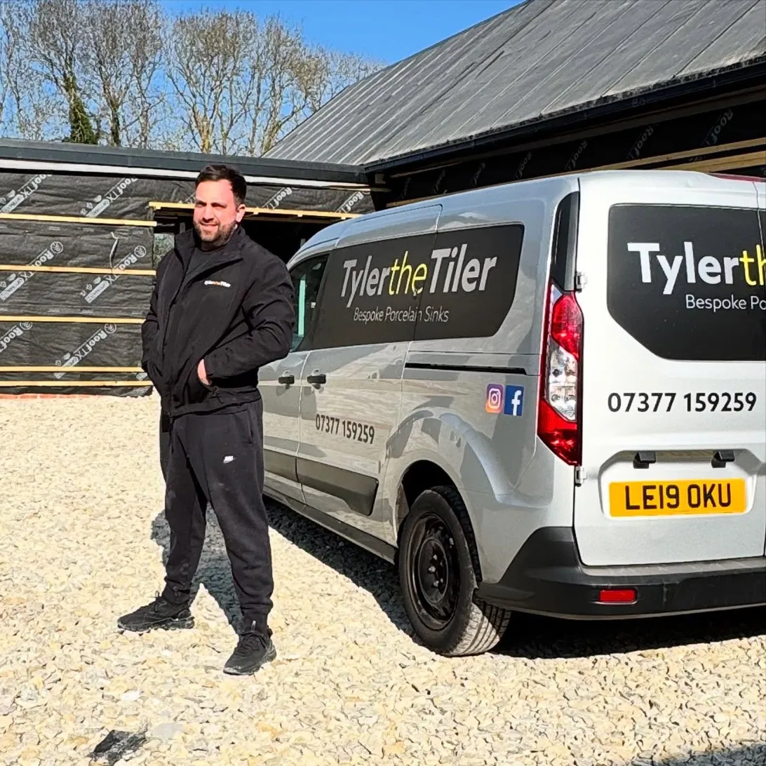 Tyler the Tiler standing beside the branded van