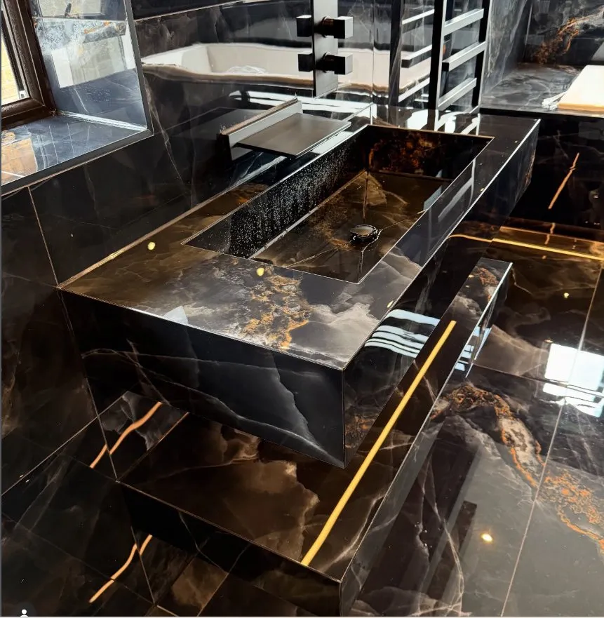 Black bespoke porcelain basin with gold veining
