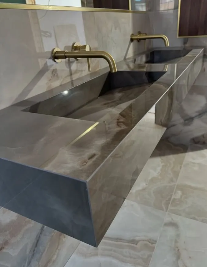 Double grey basin with brass wall-mounted taps